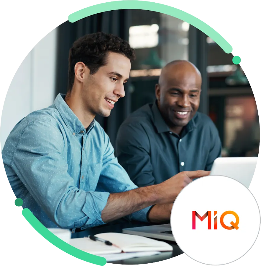Two MIQ staff looking at a laptop
