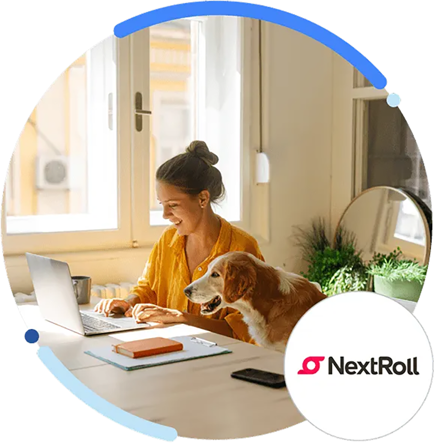 Smiling person working at laptop, with dog next to them
